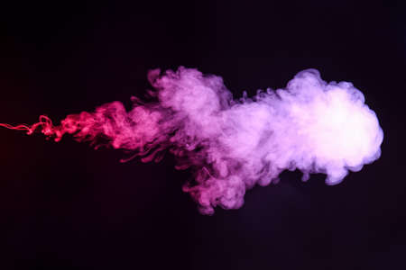 Color smoke on dark backgroundの写真素材