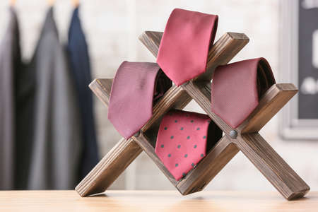 Stand with stylish neckties on table, closeupの写真素材