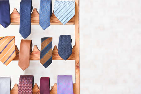Wooden stand with different stylish neckties, closeupの写真素材