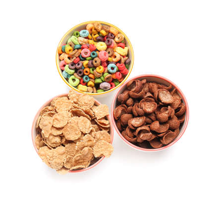 Bowls of different cereals on white background