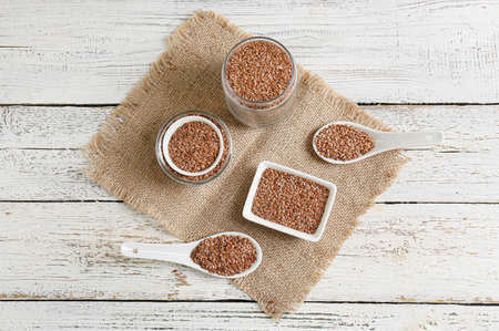 Composition with flax seeds on white wooden background
