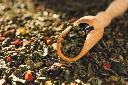 Scoop on dry green tea leaves, closeupの写真素材