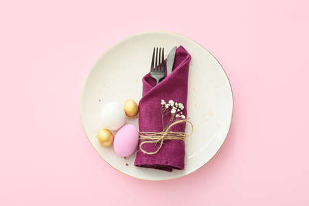 Beautiful table setting for Easter celebration on color backgroundの写真素材