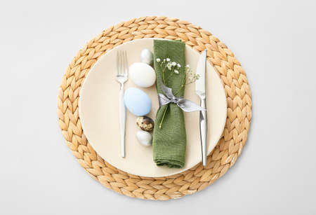 Beautiful table setting for Easter celebration on light background