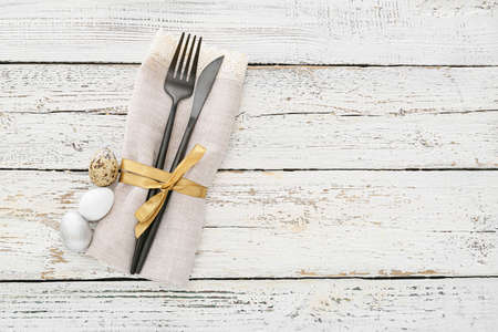 Beautiful table setting for Easter celebration on white wooden backgroundの写真素材