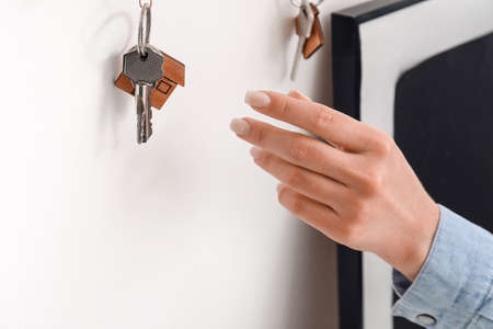 Woman with keys in room, closeup