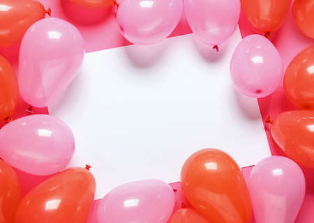 Blank paper sheet and air balloons on color backgroundの写真素材