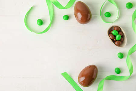Chocolate Easter eggs on white wooden backgroundの写真素材
