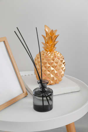 Reed diffuser and decor on table in room