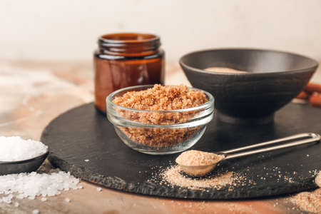 Bowl of natural scrub and ingredients on grunge background, closeupの写真素材
