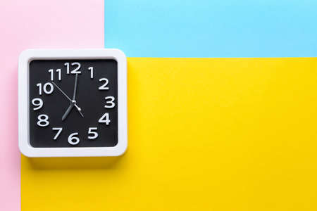 Stylish clock on color background
