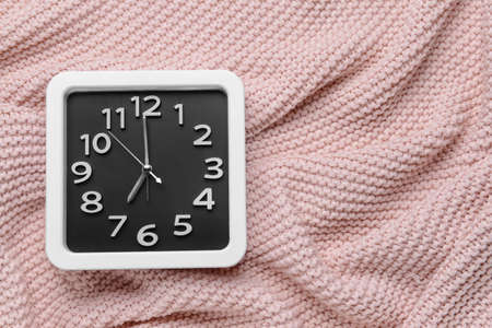 Stylish clock on fabric backgroundの写真素材
