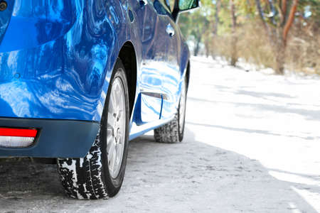 Modern car outdoors on snowy dayの写真素材