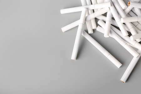 Many cigarettes on gray background