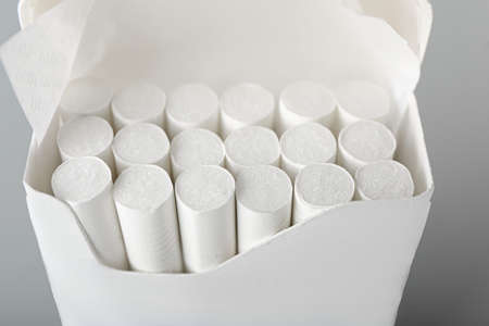 Pack with cigarettes on light background, closeup