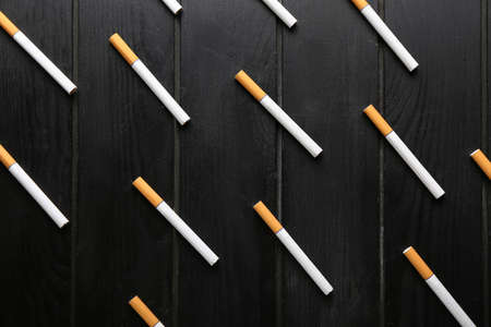 Cigarettes on dark wooden backgroundの写真素材