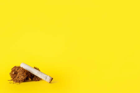 Cigarette and tobacco on color backgroundの写真素材
