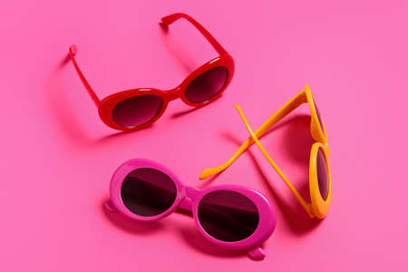 Stylish sunglasses on color background