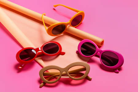 Stylish sunglasses and wrapping paper on color backgroundの写真素材