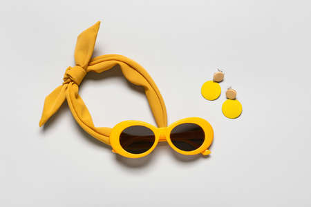 Set of female accessories with stylish sunglasses on gray backgroundの写真素材