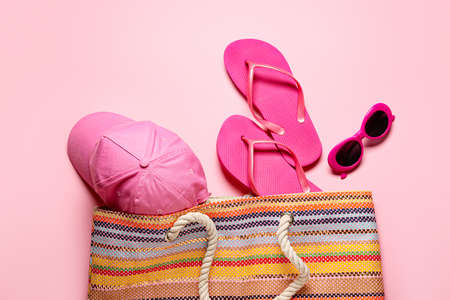 Bag with beach accessories on color backgroundの写真素材