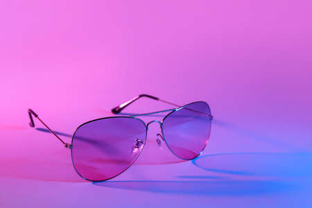 Stylish sunglasses on color backgroundの写真素材