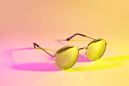 Stylish sunglasses on color backgroundの写真素材