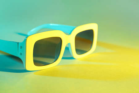 Stylish sunglasses on color backgroundの写真素材