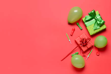 Gift boxes, balloons and candles on color backgroundの写真素材