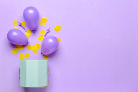 Composition with gift box, balloons and confetti on color backgroundの写真素材