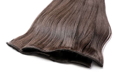 Strand of brown hair on white background