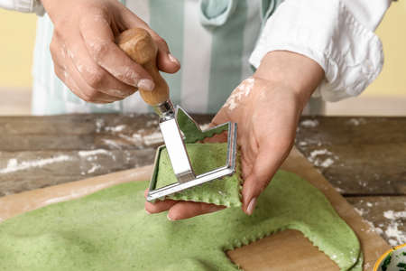 Female chef making delicious ravioli at table closeupの写真素材