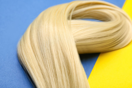 Blonde hair on color background, closeupの写真素材
