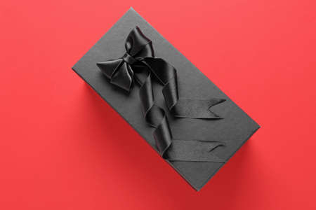 Black gift box on color background
