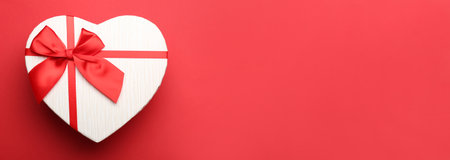 Gift box for Valentine's Day on red background with space for textの写真素材