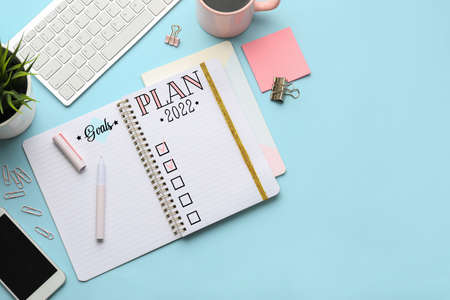 Notebook with empty to-do list for new year 2022 on color background