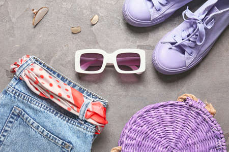 Set of female accessories with sunglasses on gray background