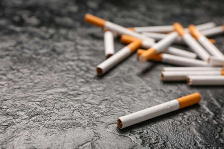 Cigarettes on dark background, closeup