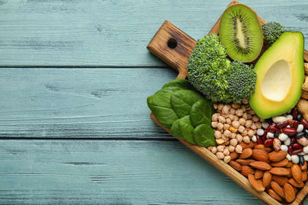 Board with healthy products rich in vitamin E on color wooden backgroundの写真素材