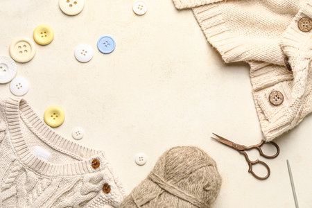 Frame made of clothes, knitting yarn and buttons on white backgroundの写真素材