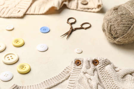 Composition with knitting yarn and buttons on white backgroundの写真素材