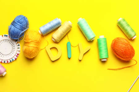 Composition with knitting supplies on color background
