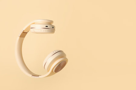 Modern headphones on color backgroundの写真素材