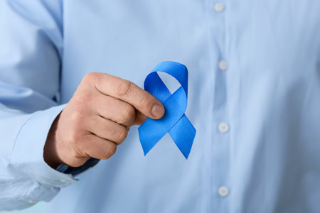 Man with blue ribbon, closeup. Colon cancer conceptの写真素材