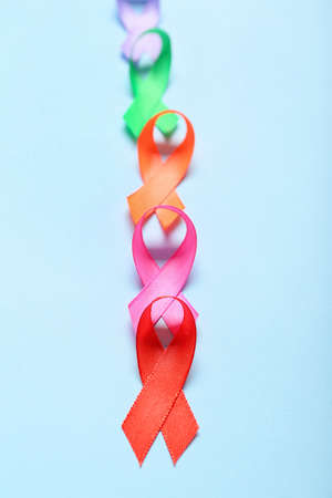Different awareness ribbons on color background