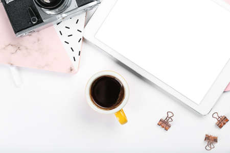 Composition with cup of coffee and tablet computer on white background
