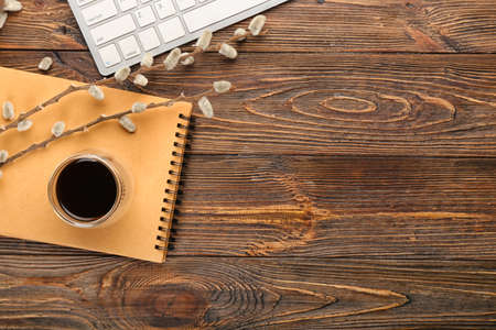 Composition with cup of coffee and notebook on wooden backgroundの写真素材