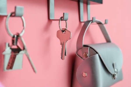 Holder with keys and bag hanging on color wall, closeupの写真素材