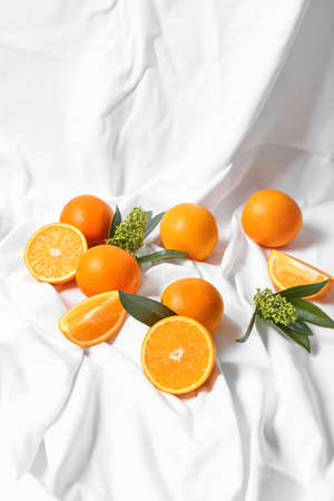 Juicy oranges on fabric backgroundの写真素材