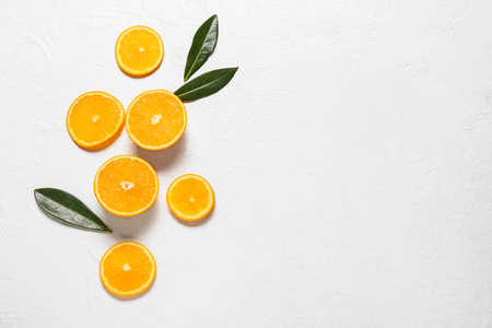 Pretty composition with sliced juicy oranges on light backgroundの写真素材